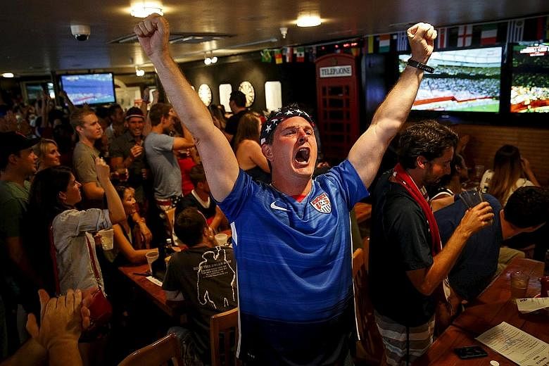 Fans celebrating while watching the Women's World Cup final football match between the United States and Japan, in Hermosa Beach, California. The game drew 25.4 million viewers - a US record for a football tie.