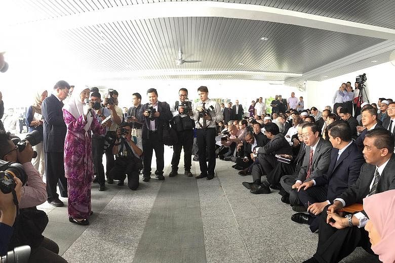 Datuk Seri Dr Wan Azizah Wan Ismail of Parti Keadilan Rakyat addressing opposition MPs in the foyer of the Parliament building in Kuala Lumpur yesterday. They held their meeting in the courtyard after being told that the room they had booked was not 