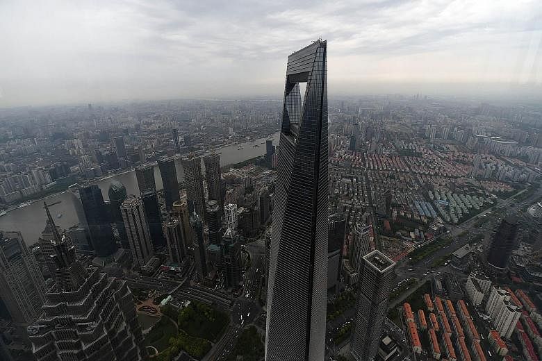 The Shanghai World Financial Centre dominating the skyline of China's financial hub. Chinese stock markets, which had risen as much as 110 per cent from last November to a peak in June, have tumbled more than 20 per cent since June 12.