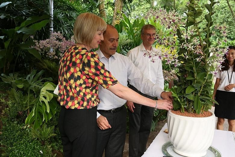 Sir Jerry Mateparae (centre) and his wife with the Dendrobium Jerry Janine Mateparae, at Singapore Botanic Gardens yesterday. With them is NParks deputy director David Middleton.