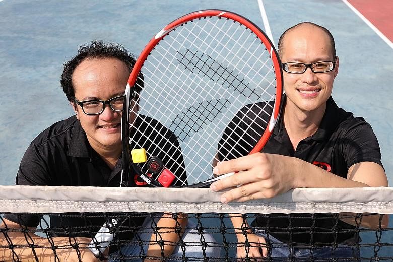 9 Degrees Freedom's co-founders Cen Lee (left) and Donny Soh with their device Qlipp, clipped to the tennis racket.