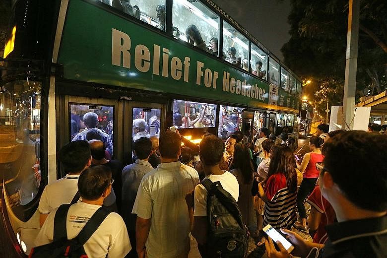 Commuters affected by the MRT train disruptions at a bus stop near Lavender station on Tuesday. Some were unable to board as the buses were already full by the time they arrived at the bus stop.