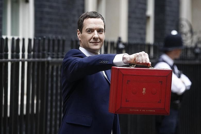 Mr George Osborne outside his official residence at 11 Downing Street holding the dispatch box containing his seventh Budget - but the first by a solely Conservative government in almost two decades.