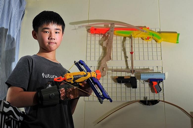 Nah Yee Chern with some of his inventions. The St Joseph's Institution student, who has been making his own toys since he was eight years old, intends to become an engineer or a game designer when he grows up.