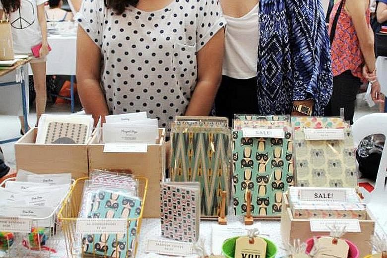 Sisters Hazirah (far left) and Fajrina Rahim and their range of stationery at a craft market.