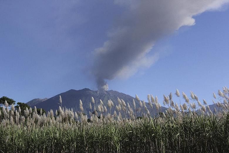 A smoking Mount Raung earlier this week. The volcanic ash has been drifting towards Bali's airport.