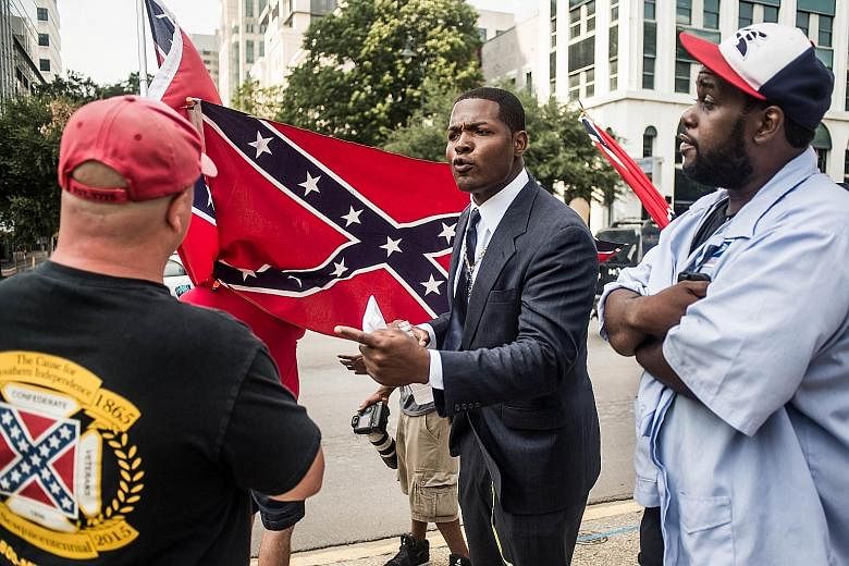 A scene outside the South Carolina State House on Tuesday. The Confederate banner was originally raised atop the building in 1961 in what was described as a commemoration of the centennial of the Civil War. Others, however, saw it as a slap in the fa