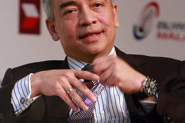 CIMB Islamic Bank CEO Badlisyah Abdul Ghani (above) posted on Facebook that there were discrepancies in WSJ's documents on the alleged funds transfer to Prime Minister Najib Razak's accounts. CIMB Group chairman Nazir Razak (left) later said that Mr 