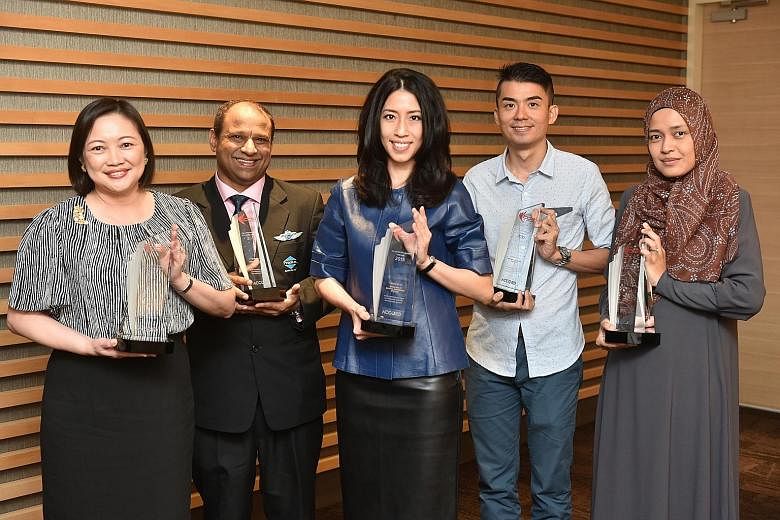 Recipients of the revamped Total Defence Awards (from left): Mrs Carol Lim, principal of Evergreen Secondary School; Mr Mohamed Ismail Gafoor, CEO, PropNex Realty; Mrs Grace Chong-Tan, managing director of Smile Inc Dental Surgeons; Mr Patrick Koh, N