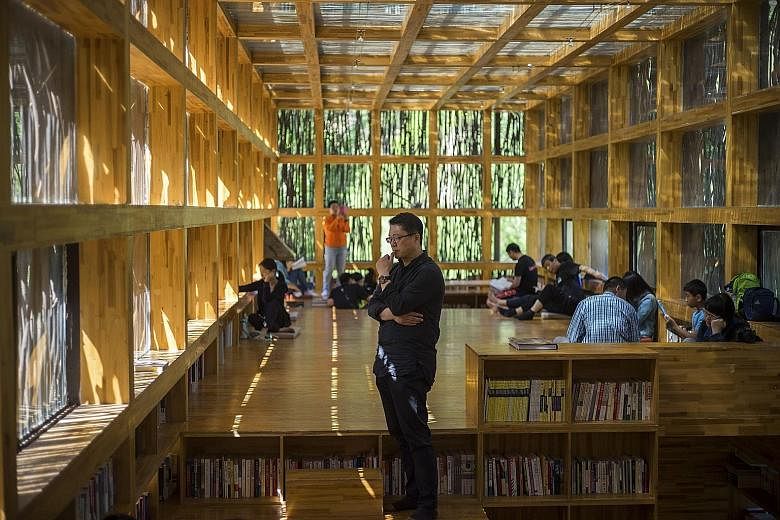 The twigs act as a camouflage for the library (above and above right). Designed by architect Li Xiaodong (centre), the library in Jiaojiehe has one large room lined with open bookshelves and elevated reading platforms.