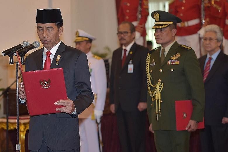 President Joko Widodo at the swearing-in ceremony of General Gatot Nurmantyo (right) as armed forces chief at the presidential palace in Jakarta this week.