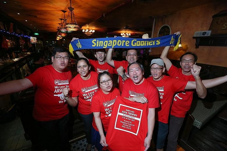 The Official Arsenal Singapore Supporters Club hosted an event in which they distributed to members match tickets and commemorative T-shirts on Thursday ahead of the Barclays Asia Trophy.
