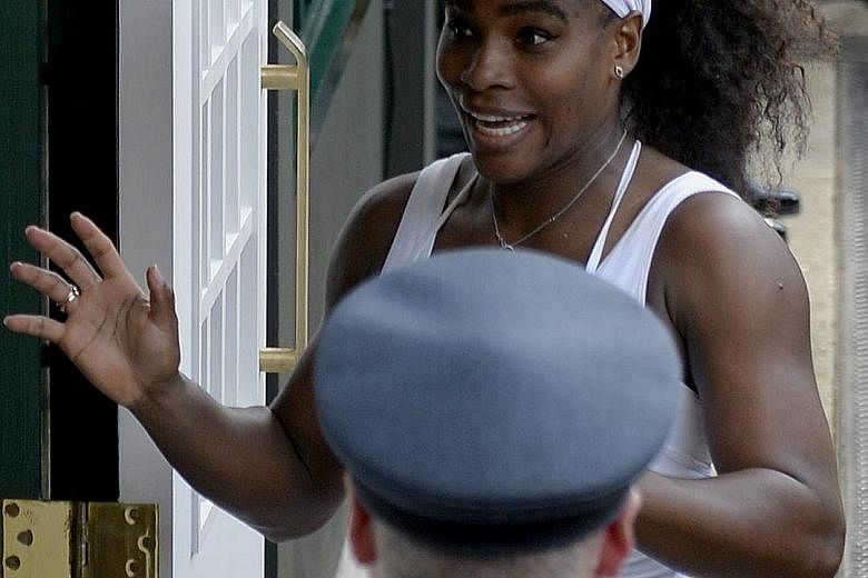Williams holds the Venus Rosewater Dish, awarded to the Wimbledon women's winner, for the 6th time in her career.