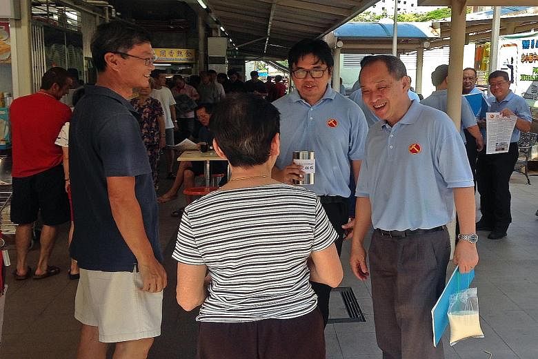 Aljunied GRC MP and Workers' Party secretary-general Low Thia Khiang (right) meets Kaki Bukit residents during a Sunday walkabout.