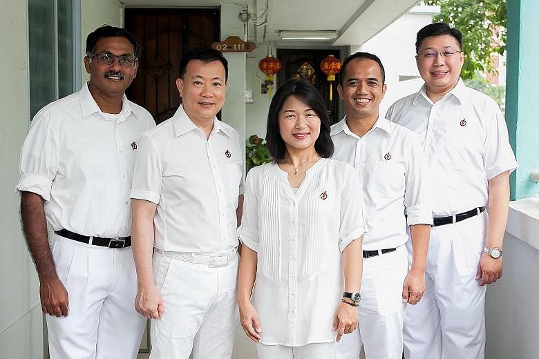 Aljunied GRC MPs from the Workers' Party (from left) Chen Show Mao, Sylvia Lim, Muhamad Faisal Abdul Manap, Low Thia Khiang and Pritam Singh at their town council office in Hougang. The PAP's team in Aljunied GRC comprises (from left) branch chairmen