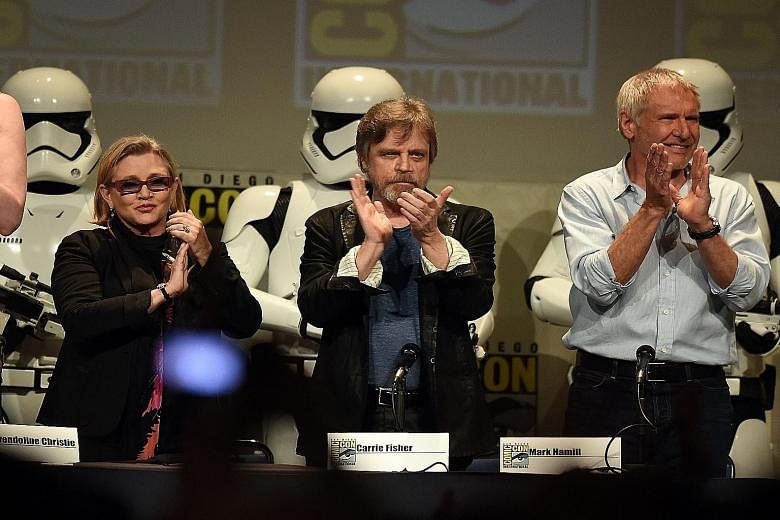Stars from the original Star Wars (from right) Carrie Fisher, Mark Hamill and Harrison Ford at the Lucasfilm panel during Comic-Con International.