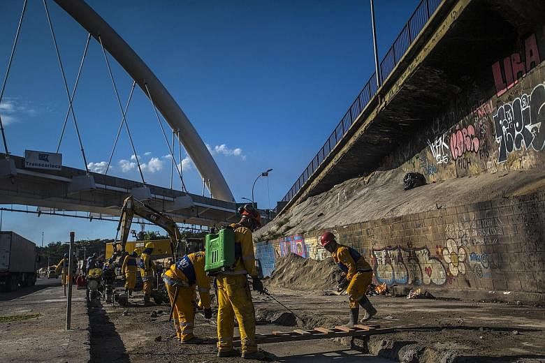 Workers at a Brazil Rapid Transit construction site in Rio de Janeiro's Brasil Avenue. Singapore companies can share their infrastructure concepts with Latin America as the region has a "$170 billion infrastructure gap", says IE Singapore's divisiona