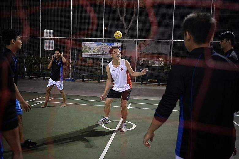 Dr Tan Lai Yong playing sepak takraw with migrant workers at Westlite Dormitory in Mandai Estate on June 25.