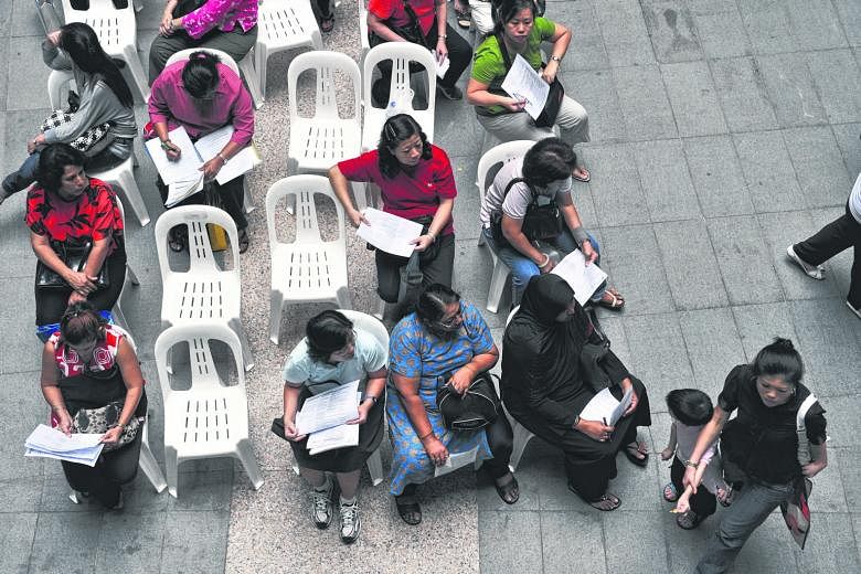 Women queuing at a job fair at Singapore Management University in 2009.