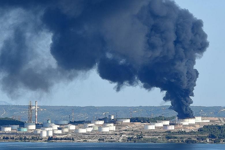 Smoke billowing from a fire at a petrochemical plant operated by LyondellBasell in Berre-l'Etang, near Marseilles, in southern France yesterday, after two explosions earlier in the morning, a source in the investigation said. Police said no one was i