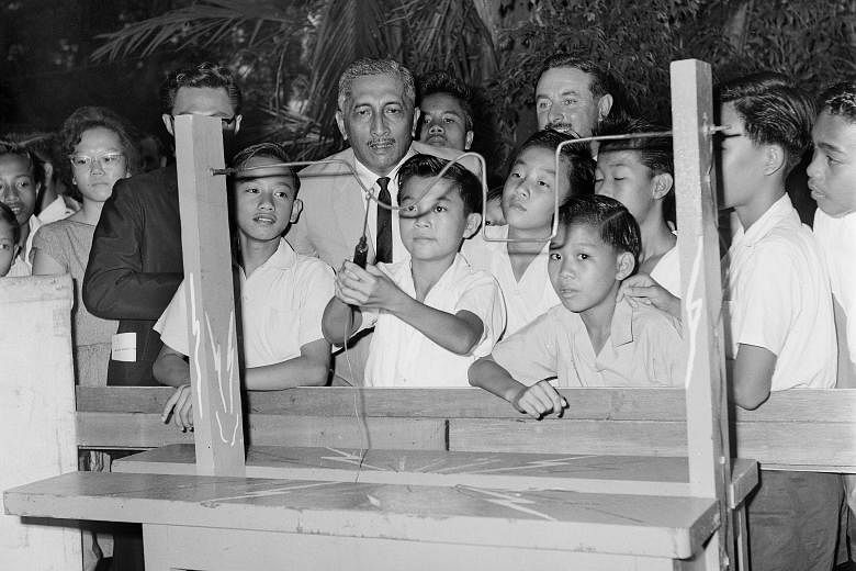 Mr Yusof Ishak with pupils at a fair in 1964. He was the country's head of state after it achieved self-government in 1959, and later became the first president of an independent Singapore. He played a key role in helping to restore the trust and con