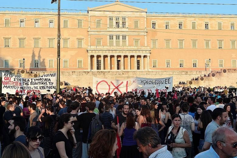 Protesters in an anti-EU demonstration in Athens on Monday rallying against the deal struck between Greece and its European creditors. Under the deal, Athens must push through draconian reforms in a matter of days.