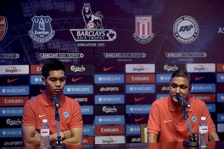 Singapore Selection goalkeeper Izwan Mahbud (left) and coach V. Sundramoorthy at a news briefing yesterday. Izwan has been earning rave reviews for his recent performances for the national team.