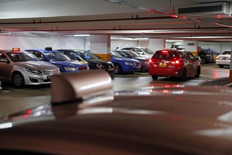 Some taxi drivers forgo peak-hour earnings to gamble. Cabs parked in a Jalan Bukit Merah carpark on a Friday evening (above) near two Singapore Turf Club outlets, and punters entering an outlet. 