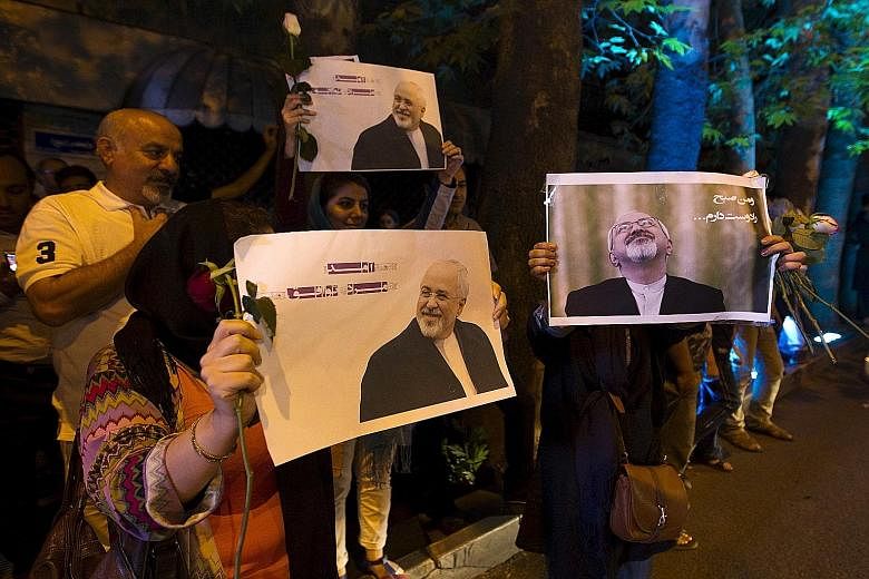 Iranians displaying pictures of Foreign Minister Mohammad Javad Zarif as they celebrated in the streets of Teheran after the country struck a nuclear deal with major world powers on Tuesday, a move seen as a game-changer.
