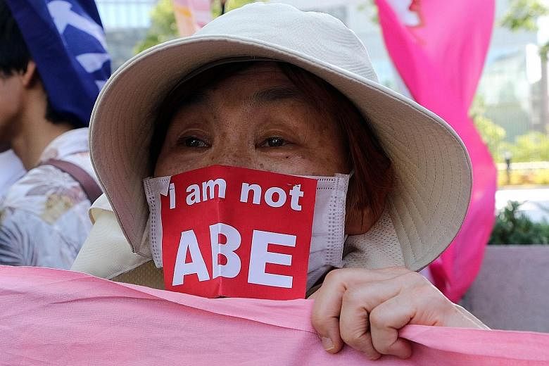 A protester outside the Parliament building in Tokyo yesterday during a rally against the security Bills. Japanese leader Shinzo Abe is determined to push the legislation to expand the role of the military through Parliament, despite most voters oppo