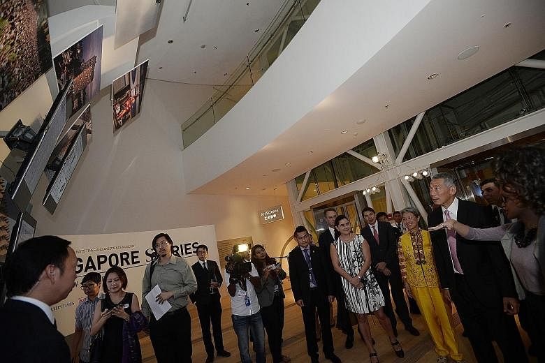 [ ]Prime Minister Lee Hsien Loong and his wife Ho Ching at yesterday's launch of the ST170 exhibition, Singapore STories: Then. Now. Tomorrow, which depicts Singapore's history through the pages of The Straits Times.