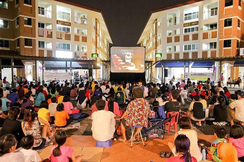 Residents of Tampines North enjoying one of their free movie screenings - under the stars - at the community courtyard beside Block 480, Tampines Avenue 9.