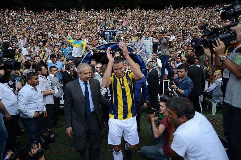 Dutch striker Robin van Persie arriving to a raucous greeting by a sea of Fenerbahce fans at his signing ceremony. The 31-year-old left Manchester United after just three seasons, following eight years at Arsenal.