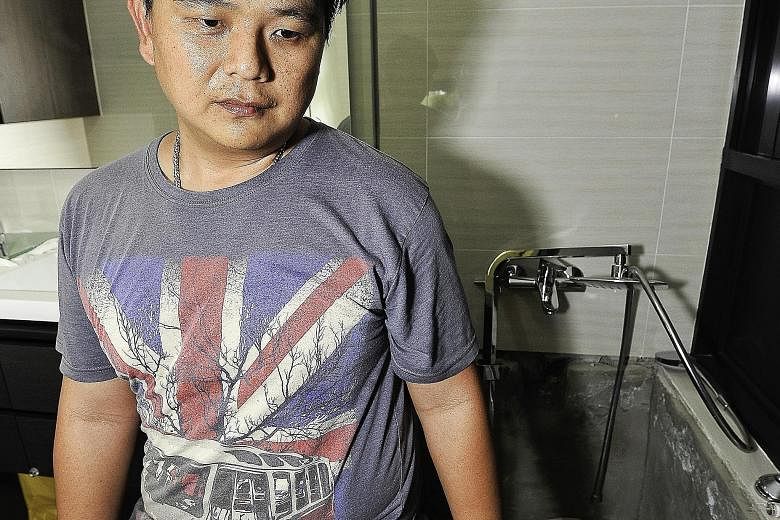 Mr Fabian Tan (above) and his family have not been able to use the master bedroom toilet for a month after workers hacked the toilet walls to trace the source of the stench. Mr Tan first noticed the stench when he moved into his RiverParc Residence u