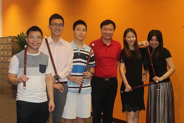 Festival artistic director Zhan Yongming (in red polo shirt) with some of his students who will be performing with him on Saturday, and Mr Tan Qinglun, the festival's director (second from left).