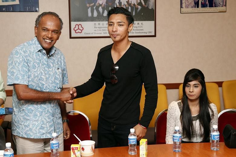Law and Foreign Affairs Minister K. Shanmugam with Mr Muhammad Hanafie Ali Mahmood, who stood up to the MRT bully. Mr Hanafie's girlfriend, Ms Nabilah Nasser (seated), filmed the incident.