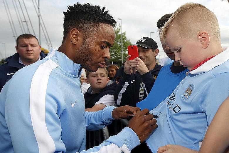 Raheem Sterling signing autographs for supporters on Tuesday, after joining Manchester City. The forward rejected contract offers of £100,000 a week from Liverpool and joined City for £49 million.