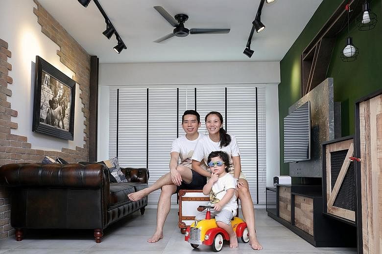 Mr Ray Tay and his wife Janet Khoo (both above, with their son Xander) bought a dark brown leather Chesterfield sofa and designed their industrial-classic retro home (left) around it. A half-height cabinet near the window in the master bedroom (left)