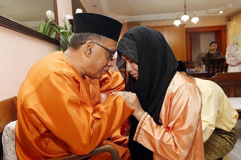 Mr Ismail Awang, 64, embracing daughter-in-law Nur Dayan Danel, 30, as his children and their families asked him and his wife for their forgiveness for any wrongdoing committed in the past year.