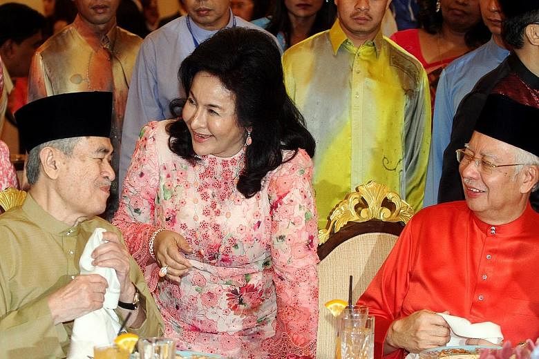Malaysian Prime Minister Najib Razak and his wife Rosmah Mansor sharing a light moment with Mr Najib's immediate predecessor, Tun Abdullah Badawi (left), at a Hari Raya open house at Seri Perdana in Putrajaya yesterday. Deputy premier Muhyiddin Yassi