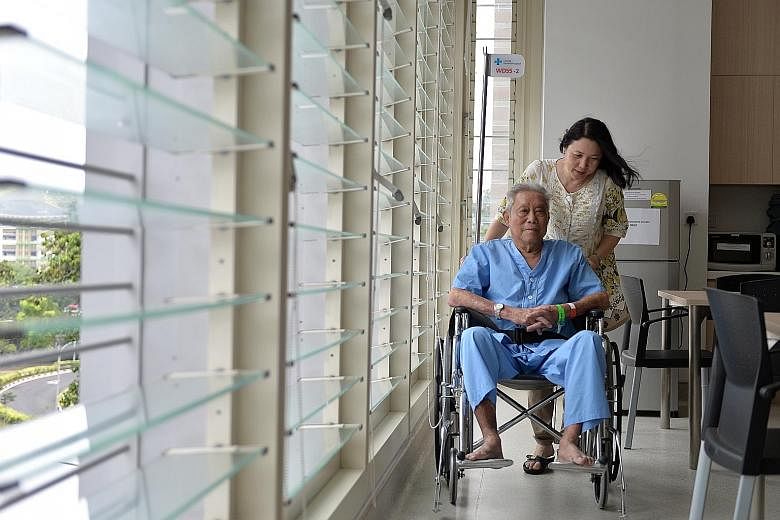 Mr Lo Chun Meng, 84, with his daughter Eileen Koh in Changi General Hospital. He opted for C class because it was the cheapest, he said.