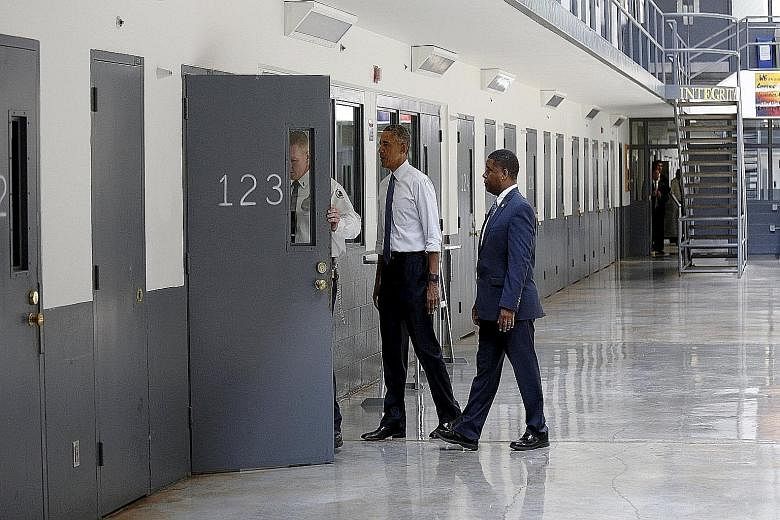 President Barack Obama is shown the inside of a cell during a visit to the El Reno Federal Correctional Institution outside Oklahoma City on Thursday. With Mr Obama are Bureau of Prisons director Charles Samuels (right) and corrections officer Ronald
