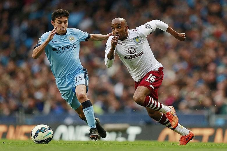 Fabian Delph (right) in action against Manchester City's Jesus Navas. The pair are now team-mates after a topsy-turvy series of events.