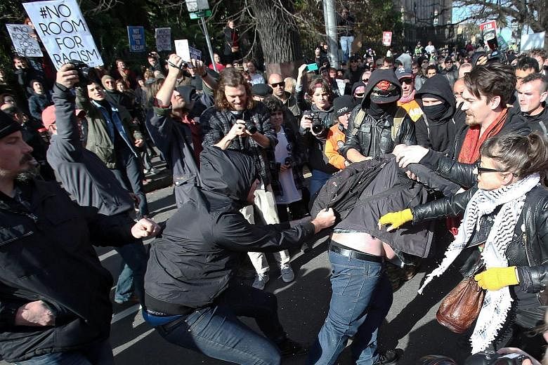 Protesters in a scuffle outside Parliament House in Melbourne yesterday, as anti-racism activists attempted to keep the nationalists from holding their "Reclaim Australia" rally. About 450 police officers were on hand, and used pepper spray as they s