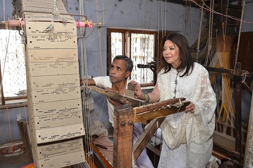 Designer Rohit Bal uses a softer fabric for the Benares sari to woo younger women to buy and wear it. Designer Ritu Kumar working with a weaver. She is one of 50 designers who are helping to revive and modernise the sari industry.