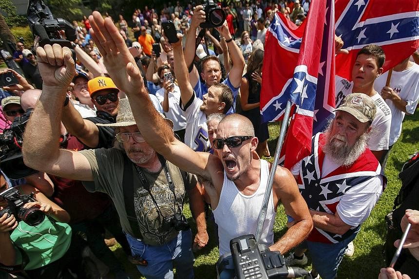 Supporters of the Ku Klux Klan and the Confederate flag yelling at opposing demonstrators during a rally in Columbia on Saturday. A Ku Klux Klan chapter and a black activist group planned the overlapping demonstrations outside the state house, where 