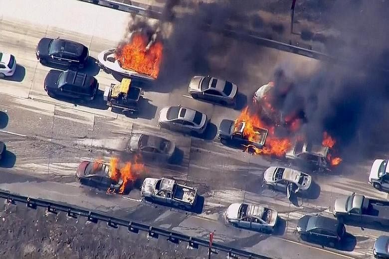 A raging brush fire in California overran the Interstate 15 freeway in mountainous Cajon Pass in California on Friday, burning 20 vehicles and forcing people to scramble to safety. Hundreds of firefighters battled yesterday to contain the fire which 