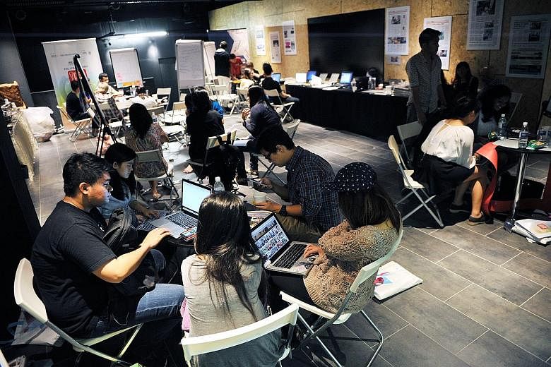 MCCY-Straits Times Idea Jam participants preparing for their presentations last October. With the help of ST journalists, participants shaped their ideas for various non-profit groups, learning about research and interviewing, before pitching them to