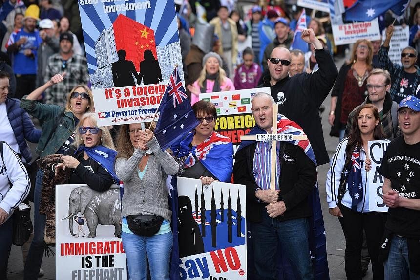 Nationalist protesters at a Reclaim Australia rally in Sydney yesterday. Similar rallies were held in other Australian cities. There were also anti-racism protests.