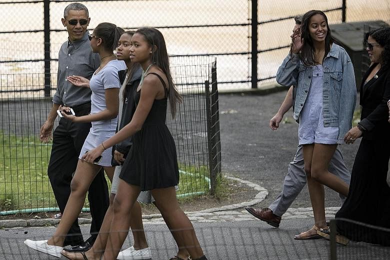 Mr Obama with daughters Sasha (second from left), Malia (right) and their friends in New York's Central Park on Friday.
